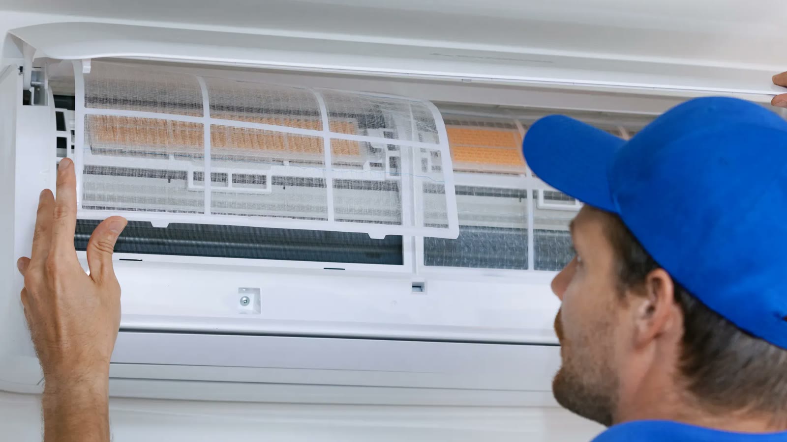 HVAC technician servicing an outdoor air conditioning unit